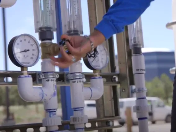 Woman manipulating a water valve