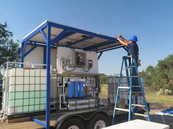 Deploying solar panels of nanofiltration unit at Dine' College Land Grant Office