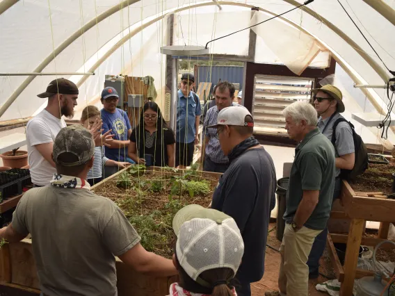 IndigeFEWSS trainees and Dine' College Land Grant Office personnel in the hoop house