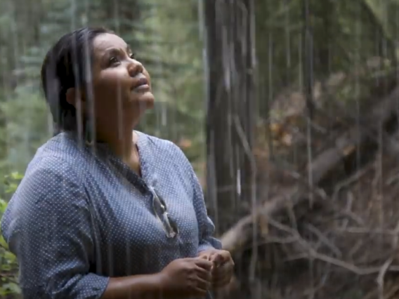 Screenshot from the video where Nikki Tulley is standing in the rain.