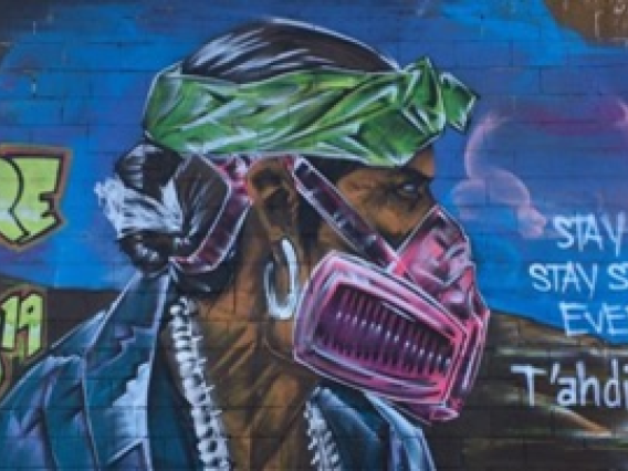 Street art depicting a person with a face mask with a quote "Beware of Covid"