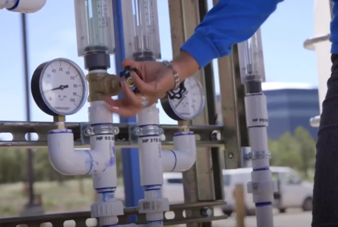 Woman manipulating a water valve