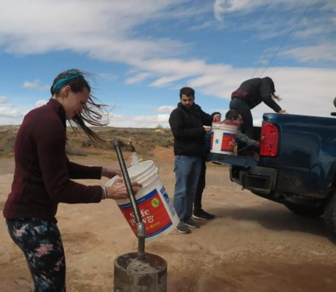 Girl filling bucket