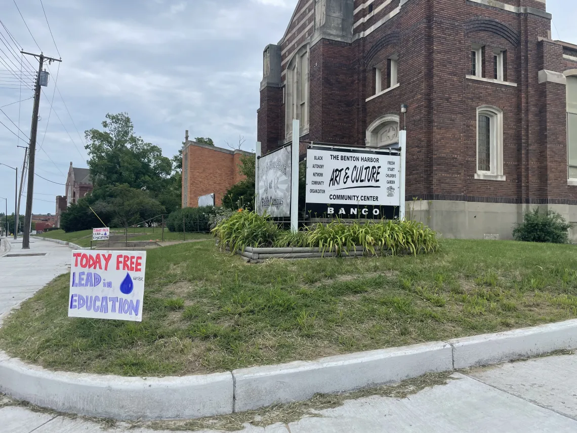 A small yard in front of a building with a sign that reads: Today Free Lead Education