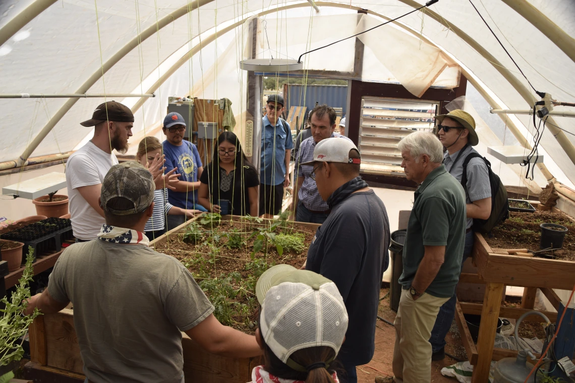 IndigeFEWSS trainees and Dine' College Land Grant Office personnel in the hoop house