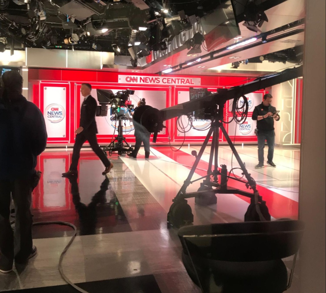 CNN News Central backdrop with some cameras and equipment in the foreground.