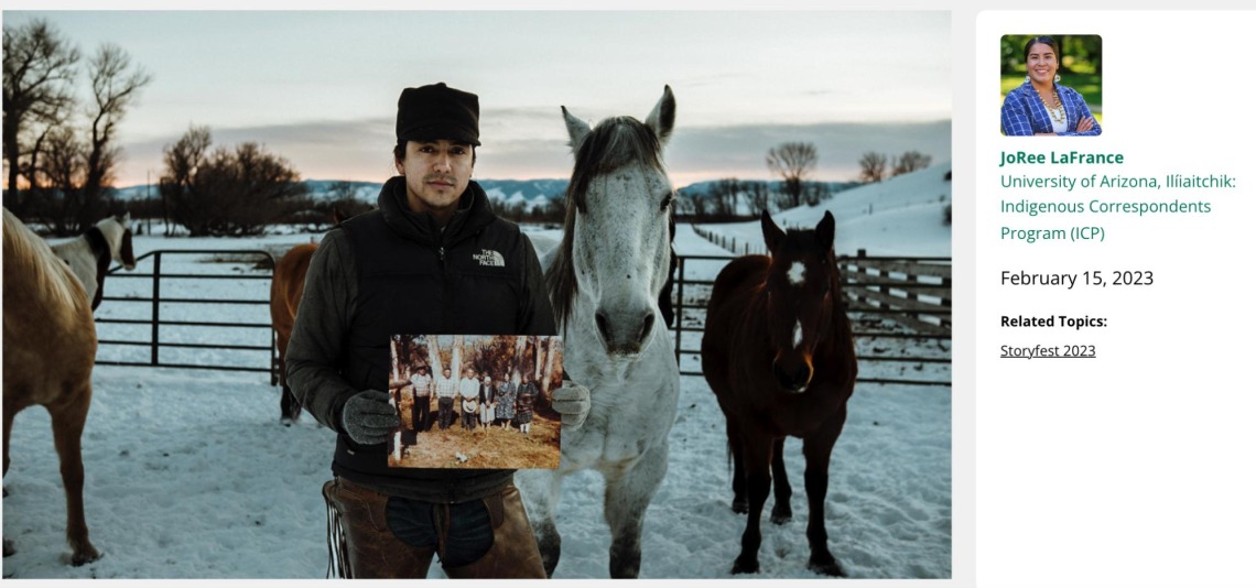 Stephen Yellowtail holding up a photo and posing next to his horses.