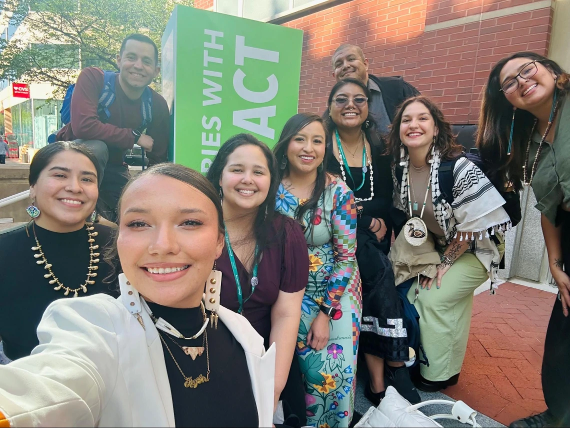 A selfie with ICP cohort and support posing at the 2025 Planet Forward Summit entrance