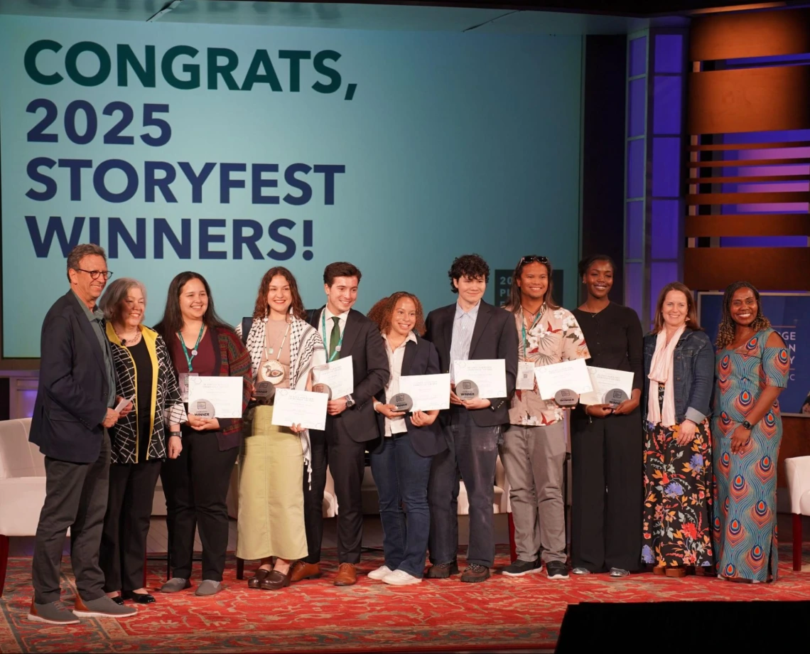 Storyfest award winners posing on stage for a photo.