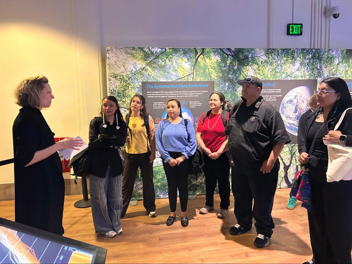 Members of the ICP program listening to a guide at the NASA Earth Information Center at the Smithsonian National Museum of Natural History.