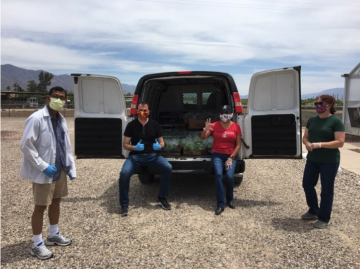 group sitting in van with produce